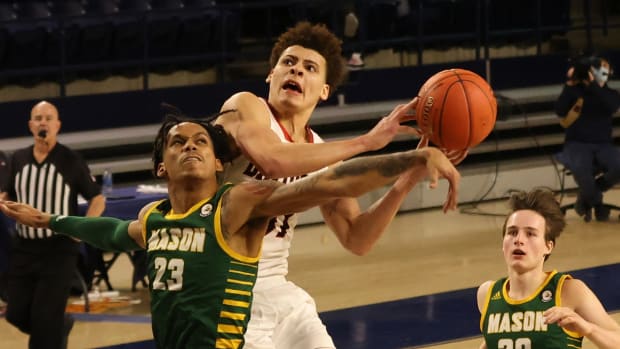 Mar 5, 2021; Richmond, Virginia, USA; Davidson Wildcats guard Kellan Grady (31) is fouled while shooting the ball by George Mason Patriots guard Javon Greene (23) in the second half of a quarterfinal in the Atlantic 10 conference tournament at Robins Center. Mandatory Credit: Geoff Burke-USA TODAY Sports